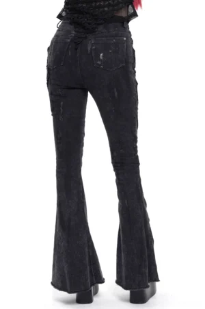 Acid-washed black gothic denim pants with distressed finish, rear view on model showing bell bottom silhouette