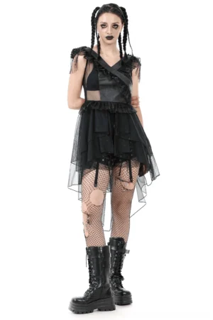Gothic lace-up corset tiered tulle dress front view on model with braided goth hairstyle, asymmetrical hem with ruffled shoulders and fishnet stockings