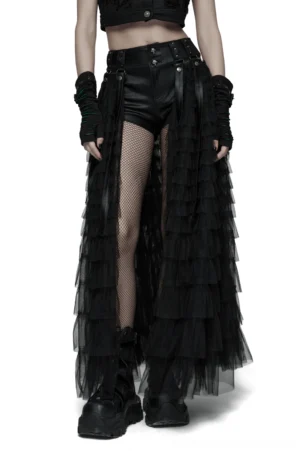 Black gothic layered tulle skirt-shorts with detachable ribbons and skull studs worn by model in three-quarter front view with fishnet stockings and boots