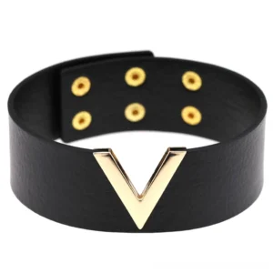 Black leather V-choker with gold hardware, front flat lay view showing geometric V-shaped metal accent and pebbled faux leather texture