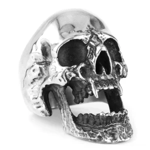 Gothic vampire skull ring with open jaw fangs, left 3/4 profile view on white background, silver-toned stainless steel