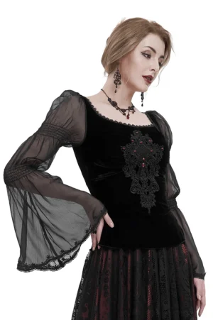 Side profile of gothic velvet blouse showing sheer ruffled long sleeves paired with dark gothic skirt