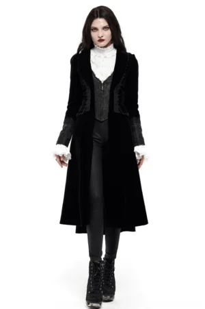 Front view of black velvet gothic long coat with lace-trimmed cuffs, modeled with matching ruffled blouse