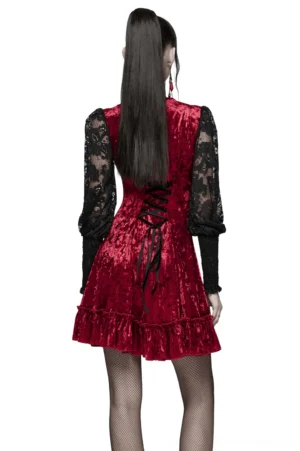 Back view of gothic lace velvet dress featuring functional corset lace-up closure, fishnet stockings, and ruffled skirt hem detail