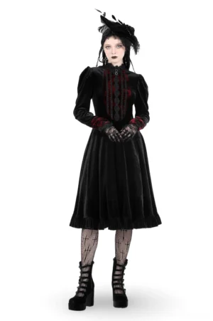 Gothic black velvet dress with red lace accents front three-quarter view on model