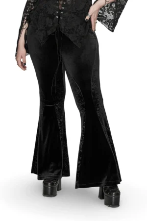 Black gothic velvet flared pants with baroque embossed side panels worn by model, three-quarter front view