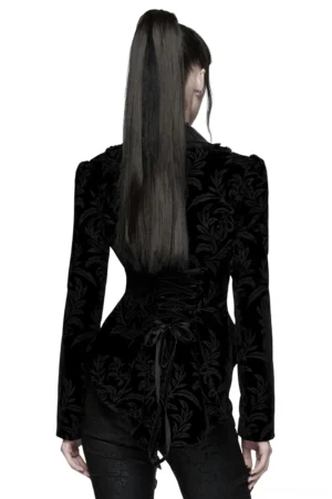 Back view of gothic velvet jacket with high-low hem and lace-up back closure on model