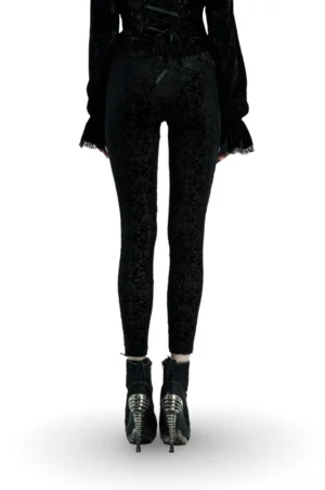 Back view of black gothic velvet leggings with burnout floral pattern and high-waisted design