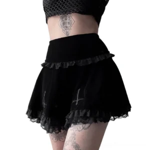 Gothic velvet mini skirt detail shot showing lace waist trim, inverted cross embroidery, and high-waist design on model
