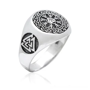 Dark Viking signet ring with Helm of Awe symbol, side oblique view showing Celtic knot engraving and black etchings on polished stainless steel