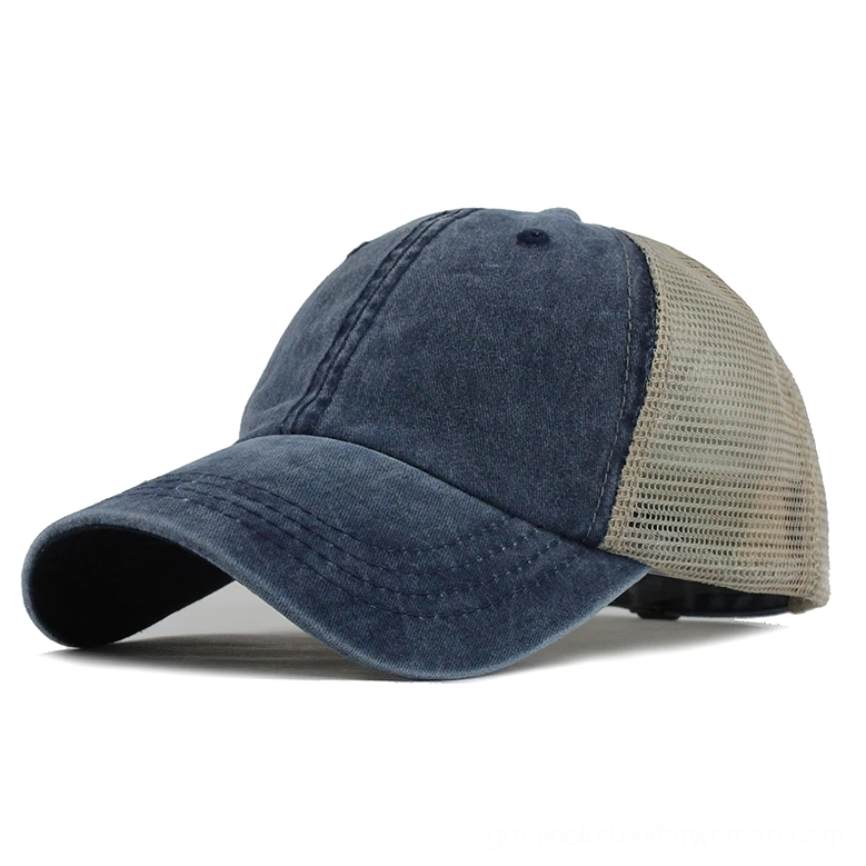 Dark navy washed gothic trucker cap with beige mesh rear panel, three-quarter left side view showcasing curved stitched visor