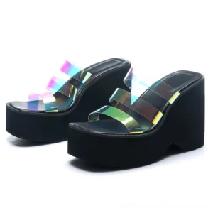 Black and white platform wedge slippers paired view showing iridescent clear straps and thick platform sole from side-front angle