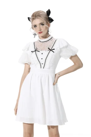 Gothic white lace dress with puff sleeves front view on model, featuring black ribbon bow trim and lace yoke detail