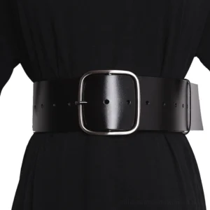 Wide black leather corset belt with square metal buckle worn on female torso in black dress, front waist view