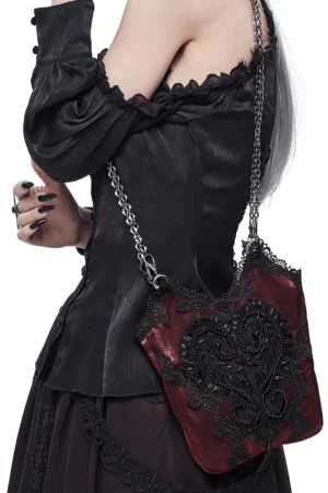 Wine red gothic crossbody bucket bag with black guipure heart lace worn by model in off-shoulder top, side back view