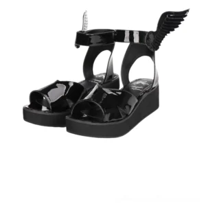 Black winged platform sandals three-quarter front view showing patent leather, angel wing ankle strap embellishment, and thick EVA sole