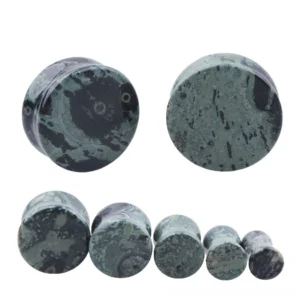 Single green eye stone ear flesh tunnel showing detailed marbled pattern and double-flanged design from front view, gothic body jewelry piercing gauge