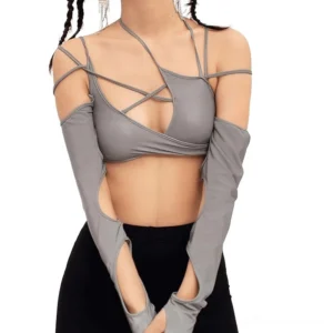 Grey halter cutout cropped long sleeve top with attached arm sleeves, front view on female model showing patchwork design