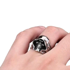 Memento mori skeleton ring worn on male hand, demonstrating comfortable fit and detailed skull motif on finger, gothic jewelry styling