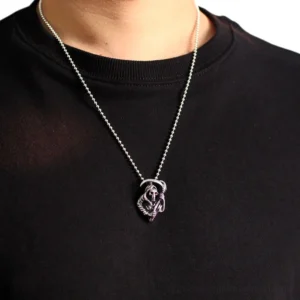 Grim Reaper gothic necklace worn on male model, chest-up view demonstrating pendant wearing effect against dark fabric
