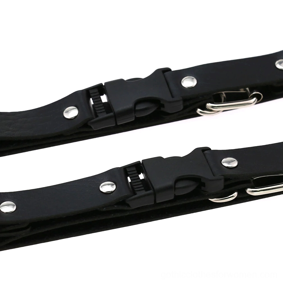 Close-up detail of leather harness fastener components including quick-release buckles, silver rivets, and metal fittings