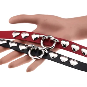 Multiple color options of heart studded leather chokers including black and red variants displayed showing metal O-ring hardware and adjustable closure mechanism