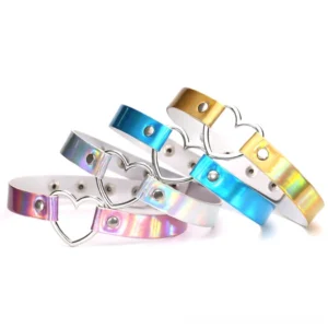 Multiple holographic heart choker necklaces in various colors displayed flat lay - Blue, Gold, Pink, and White iridescent PU leather with metal heart buckles