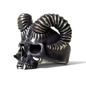 Horned devil skull gothic ring three-quarter left side view showing aged dark silver tone and lower fangs detail