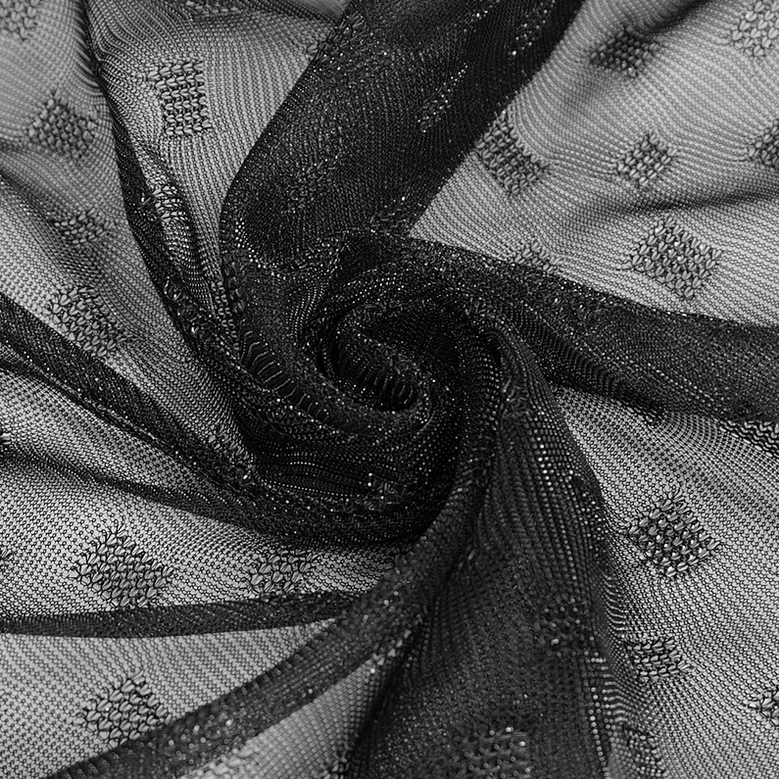 Overhead flat lay of black dotted mesh gothic skirt emphasizing asymmetrical handkerchief hem points and fabric drape