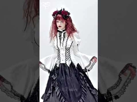 Ivory gothic lace corset blouse front view on model, featuring corset front design, lace-trimmed cuffs, long flare sleeves, and white base with black lace details