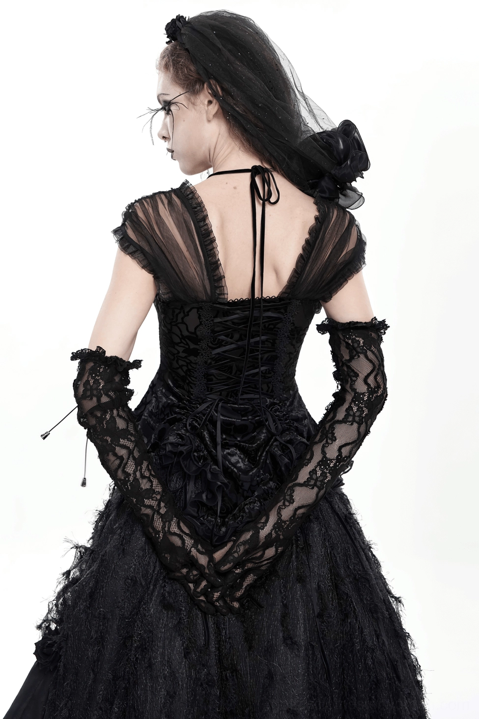 Black lace long gloves with chain details paired with gothic evening attire and jewelry