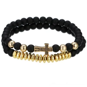 Gold lava stone cross bracelet with 8mm volcanic beads and toggle clasp, displayed on white background