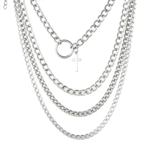 Flat lay view of complete four-piece layered chain choker set, silver link chains with cross and ring pendants, white background
