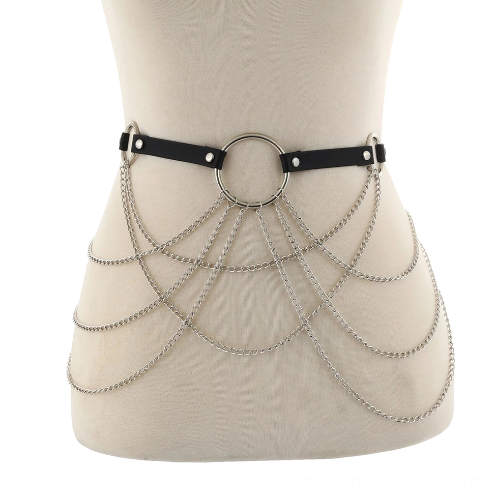 Mannequin display of black leather waist harness with draped silver curb chain and central O-ring detail close-up