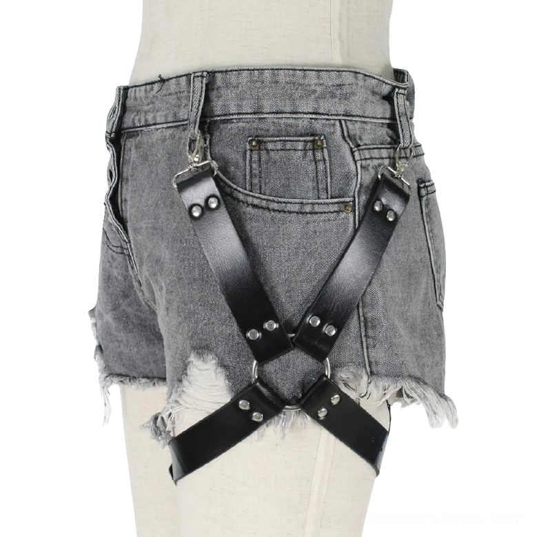 PU leather thigh harness with riveted cross straps and metal studs styled with grey frayed shorts, front angle shot