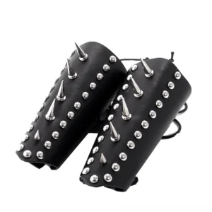 Pair of black leather wrist guards with mixed silver studs and spikes, dual lace-up straps, flat lay angled view