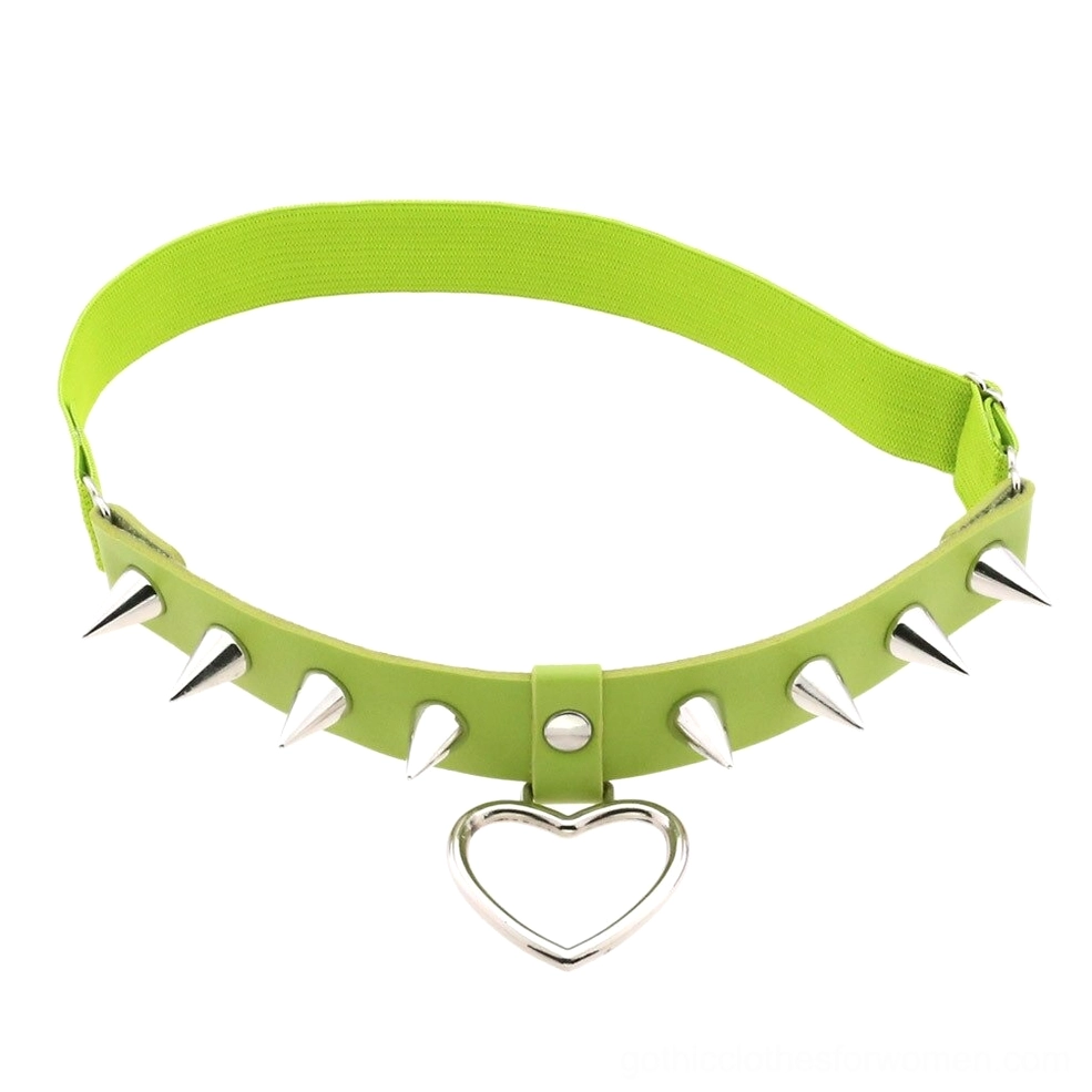 Lime green elastic leg garter with silver spikes and heart charm, alternative fashion body jewelry studio shot