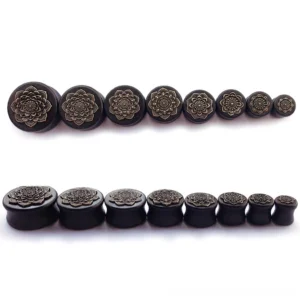 Complete size range set of 8 black wooden mandala ear gauges from 14mm to 30mm, top-down flat lay showing all available sizes