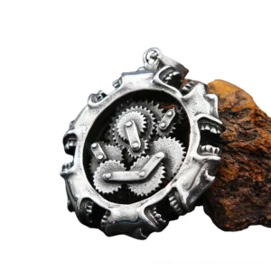 Three-quarter side view of gothic mechanical skull necklace displaying internal gear assembly on wooden block