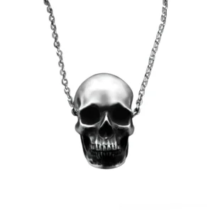 Detailed silver skull pendant with curb chain displayed on white background showing intricate teeth and cranial structure