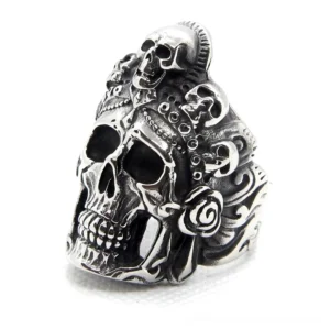 vintage multi-skull stainless steel biker ring with carved floral details, left front oblique view