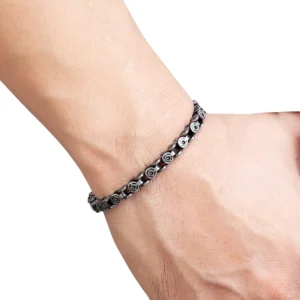 Men's dark silver punk chain bracelet worn on wrist showing side profile thin flat link design and aged metal color on white background