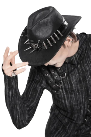 Gothic spiked cowboy hat side view on male goth model wearing studded leather top and dark outfit