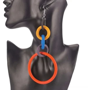 Multicolor silicone drop earrings with linked chain design, featuring yellow, blue, and orange tones on black mannequin bust