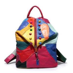 Multicolor patchwork gothic leather backpack with round bead studs, vibrant color-block panels, front view with top carry handle