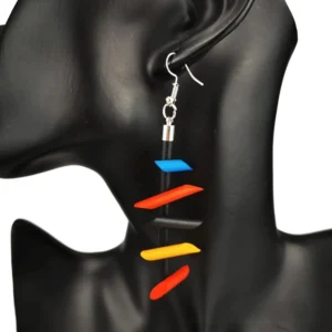 Multicolor twisted spike rubber dangle earrings gothic jewelry worn on black mannequin ear model close-up left side view