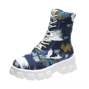 Navy dark blue brush stroke pattern gothic combat boots with chunky white platform lug sole and lace-up closure, left three-quarter view