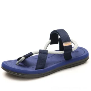 Navy blue and gray gladiator sandals with dual webbing straps, side view displaying gothic minimalist construction