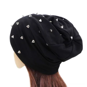 Navy blue studded slouch beanie with scattered silver metal cone studs, rear view showcasing drape