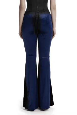 Back view of navy velvet gothic pants displaying back tie closure and dramatic flared hem detail